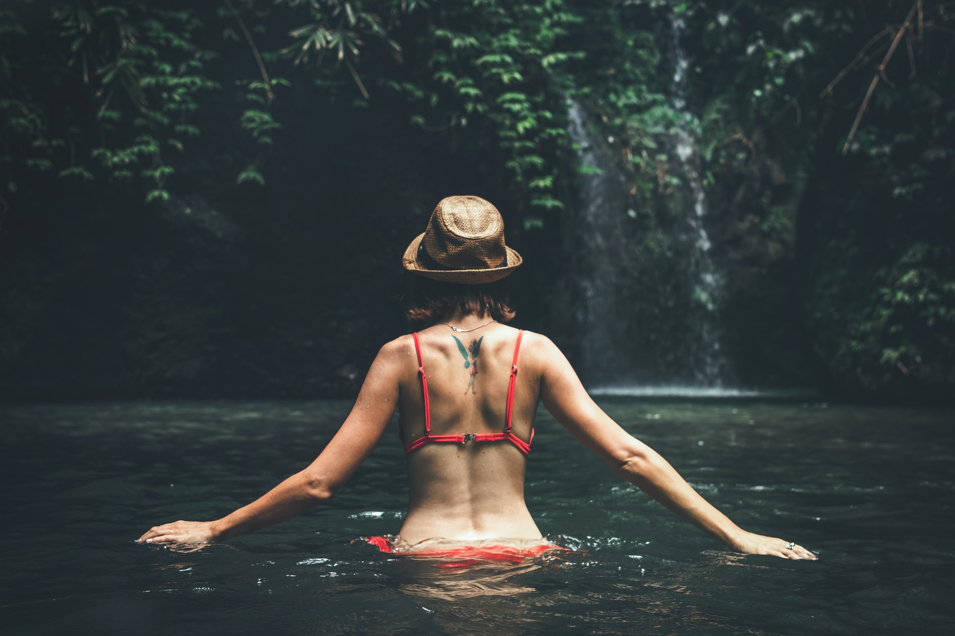woman-in-red-swimsuit-walking-on-body-of-water-1675207